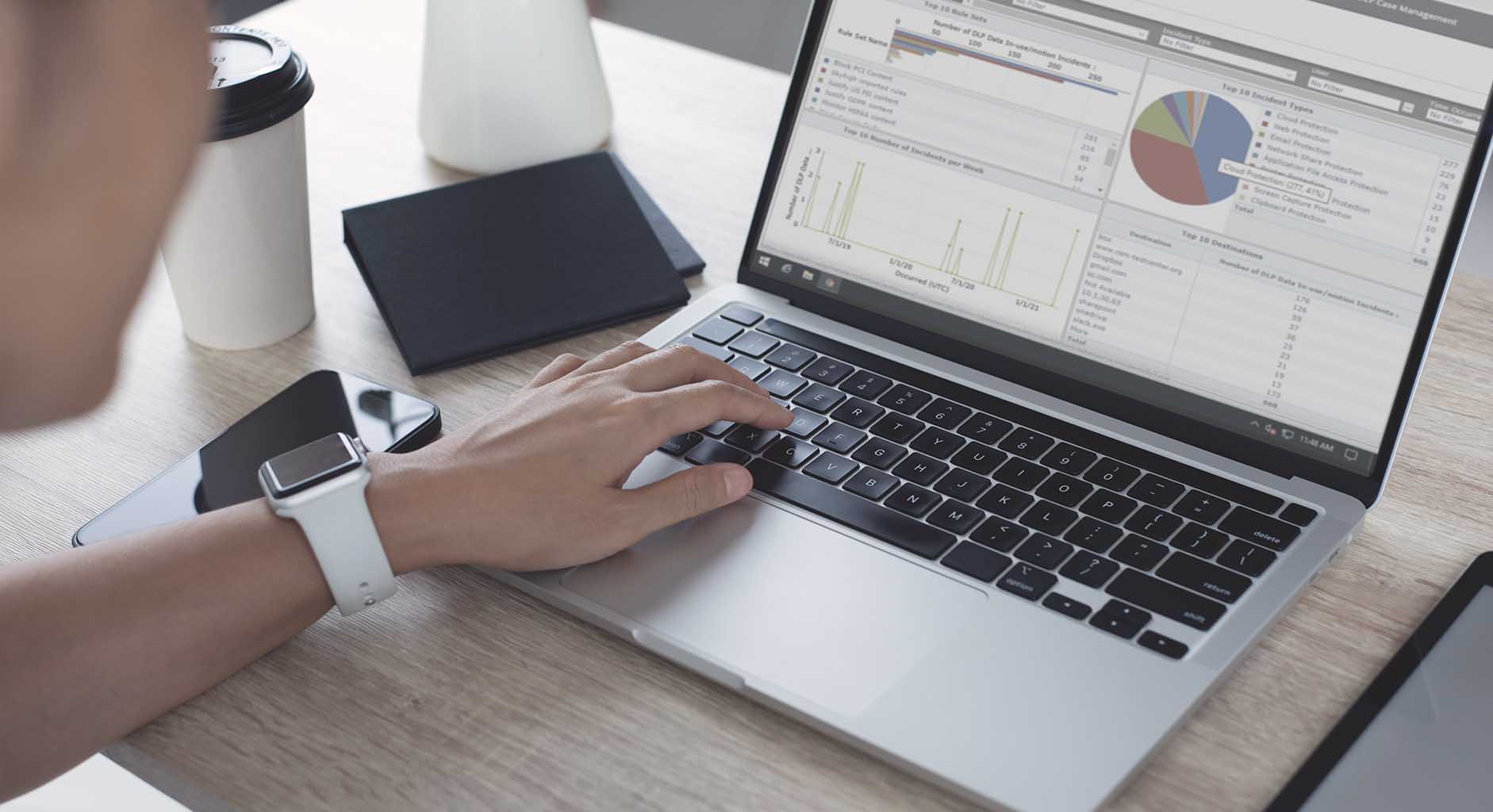 SecOps professional working with data on a laptop