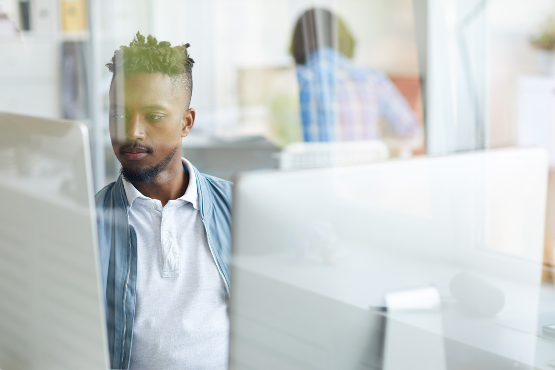 Man working at computer in bright office